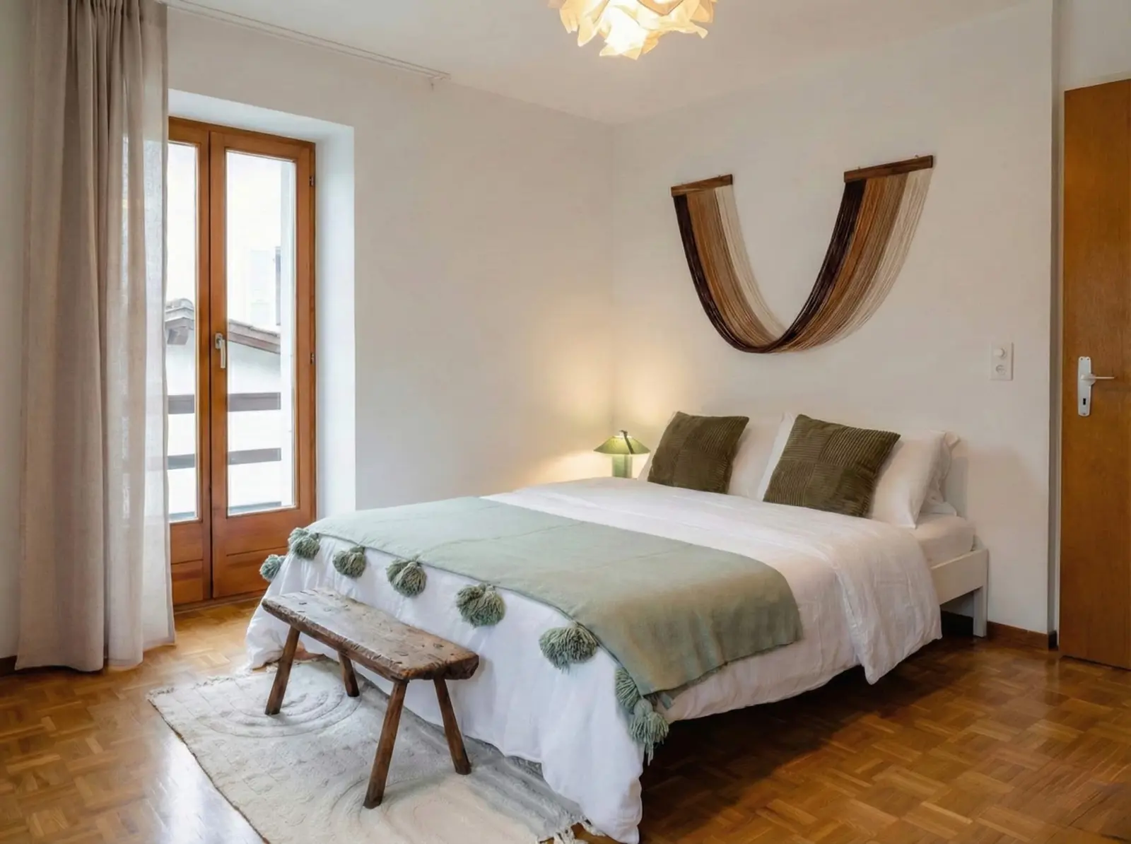 Double bedroom with wood floor in the Brione stone house