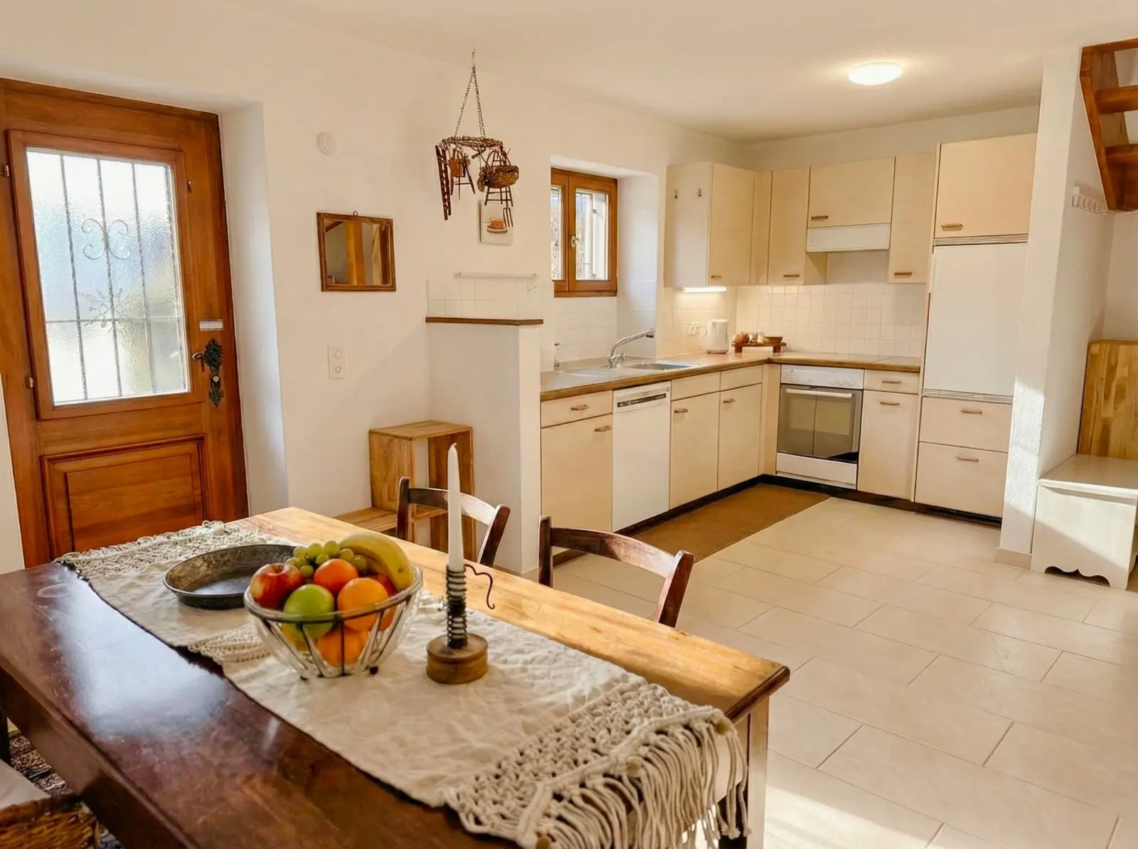 Dining table and full kitchen in the Brione stone house