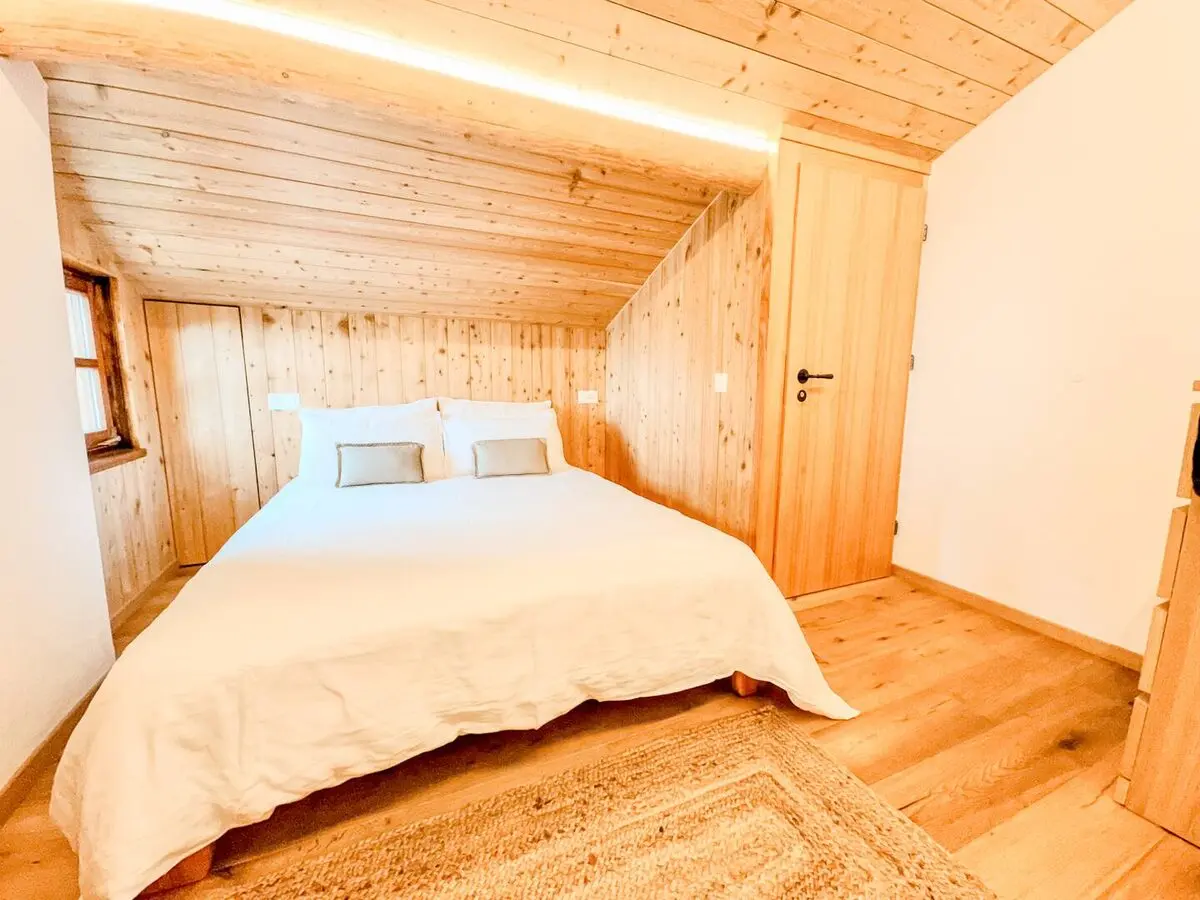 Wood-lined double bedroom at Monti Motti