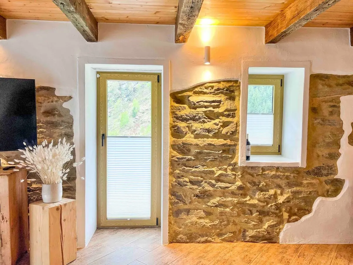 Stone interior and garden door in the Vergeletto lodge