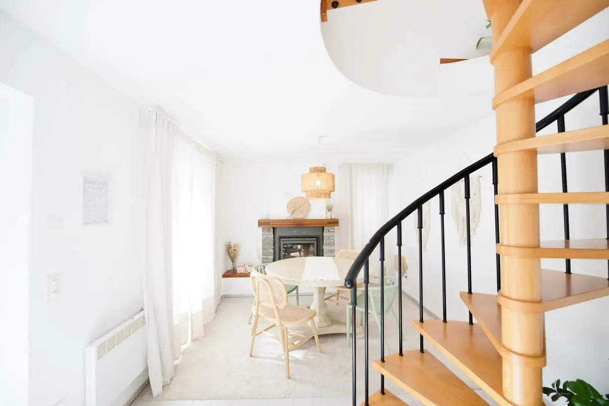 Spiral staircase and dining area in the Vira home