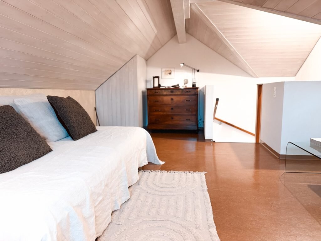 Sleep under the roof beams with the cork floor warm underfoot.