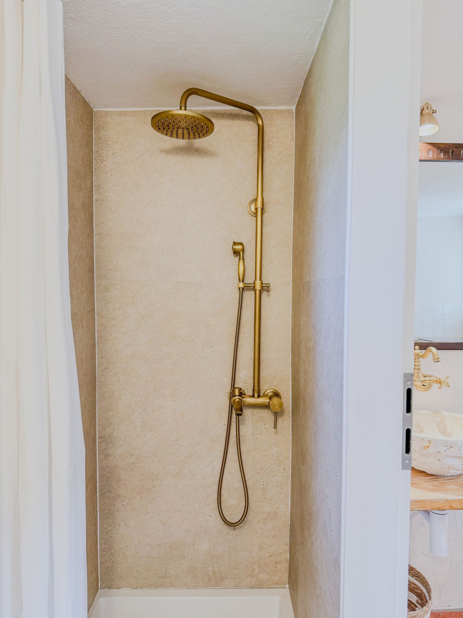 A brass rain shower worth standing under ten minutes longer.